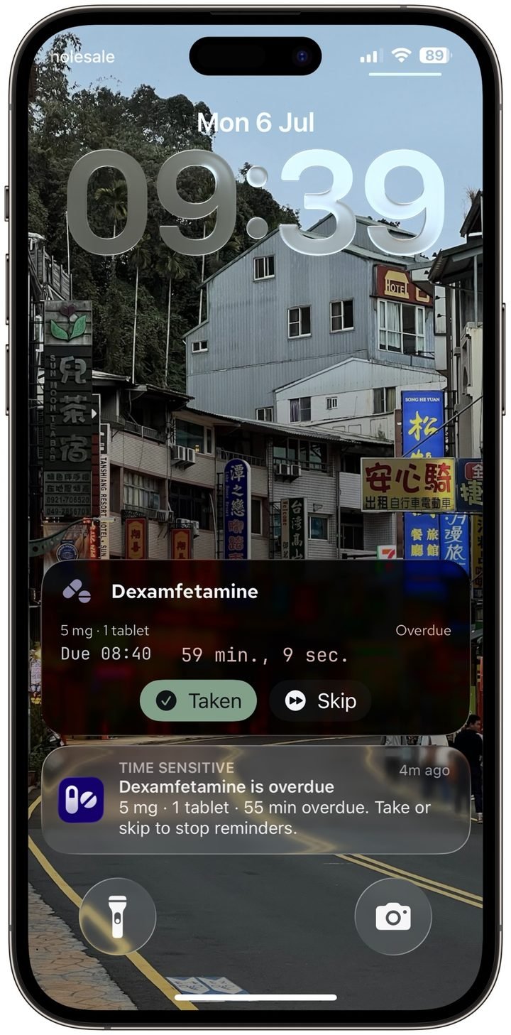 Lock screen showing an overdue Dexamfetamine Live Activity with the Overdue label and elapsed time, above a Time Sensitive reminder notification with the same details