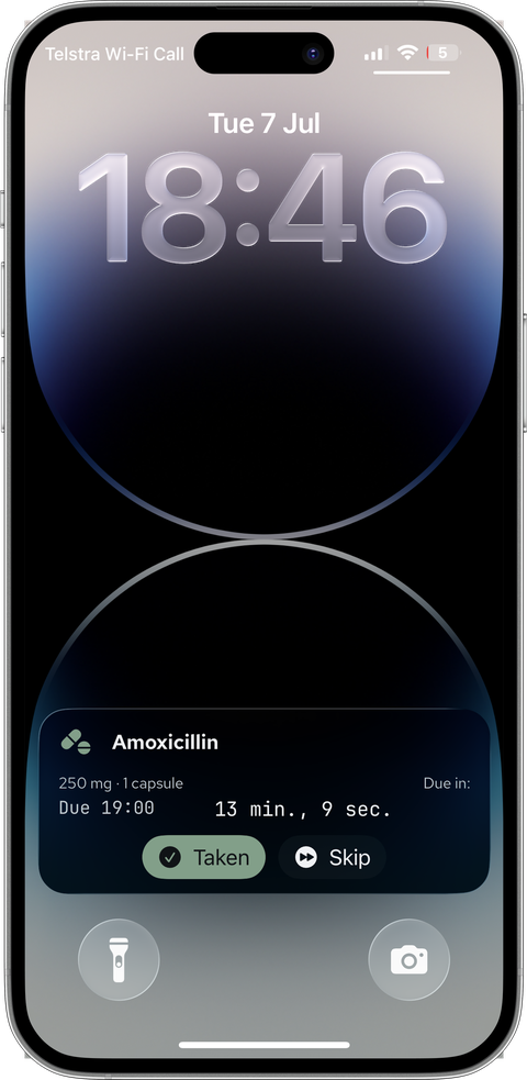 Silver iPhone lock screen with a PillBox Live Activity counting down 13 minutes to an Amoxicillin dose, with Taken and Skip buttons