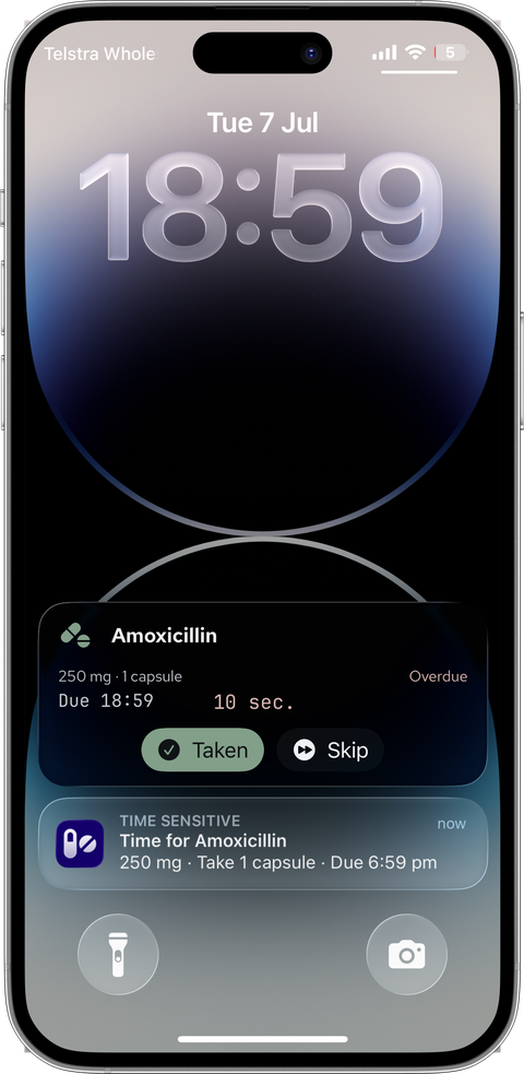 Silver iPhone lock screen at due time: the Live Activity flips to overdue and a Time-Sensitive notification says Time for Amoxicillin