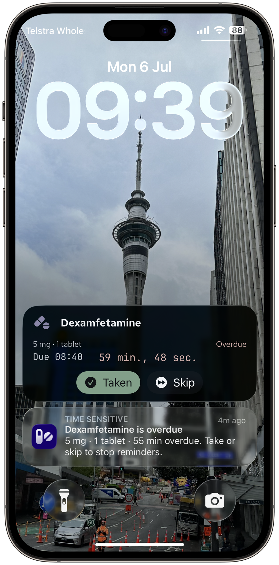 iPhone lock screen showing a PillBox Live Activity counting down an overdue dose, with Taken and Skip buttons and a Time-Sensitive notification